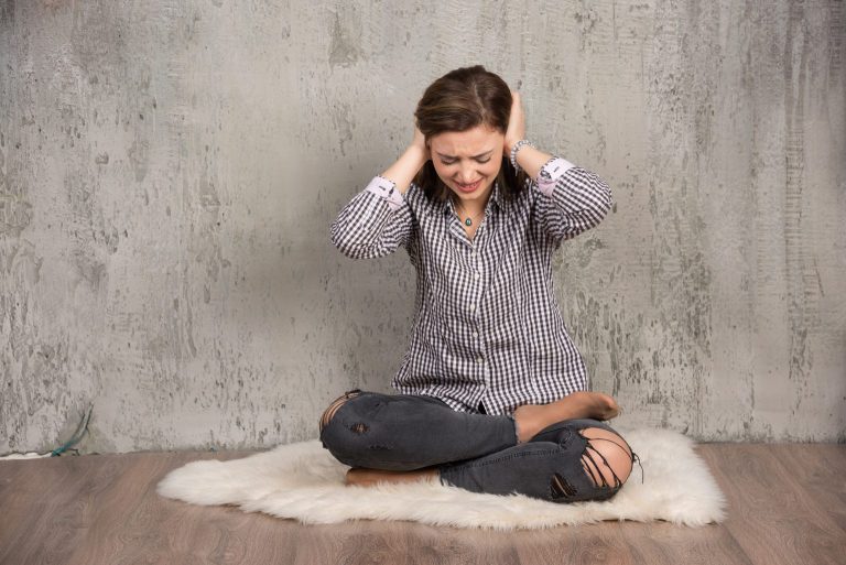 beautiful-young-woman-covering-her-ears-with-her-hands-closes-her-eyes-1536x1025